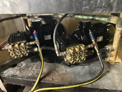 Replacement pumps and motors fitted on a multi-pump pressure washer system during repair work at a malt house in Burton.